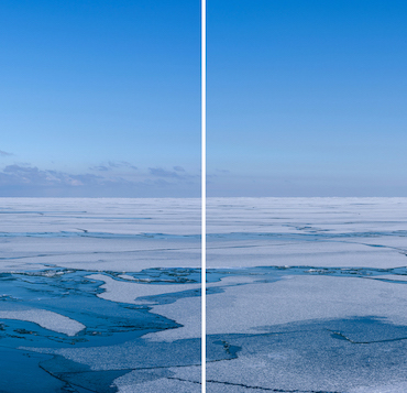 icy lake michigan sits under clear blue skies in a panorama photo