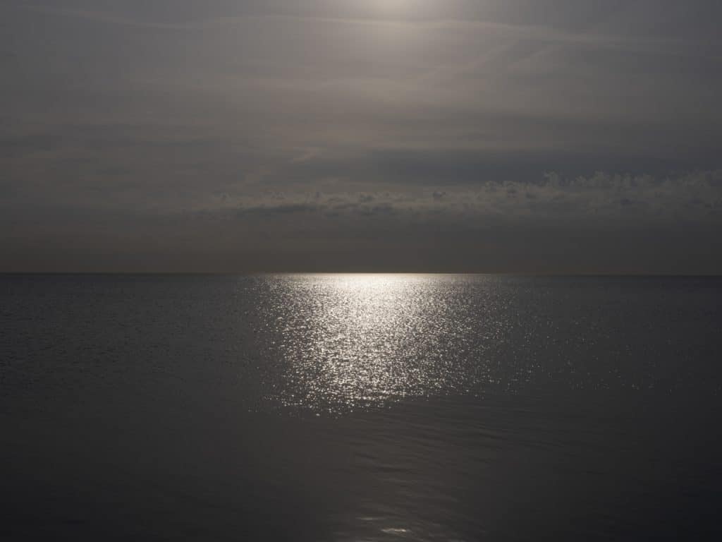 The clouds are heavily filtering the sun early on this morning over Lake Michigan that results in golden lake light. Creating an otherworldly landscape in bronze and golden light.