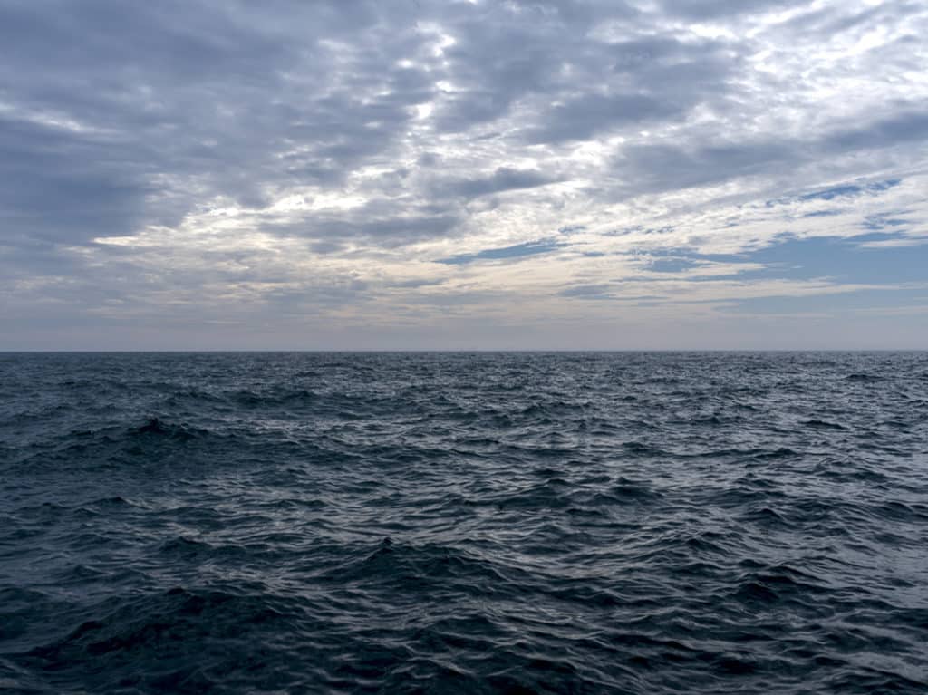 The lake churns in dark blue tones on an early morning in May 2018. Just as spring shifted to summer and warmer days took over. The final storms of spring bringing more water to the lake.