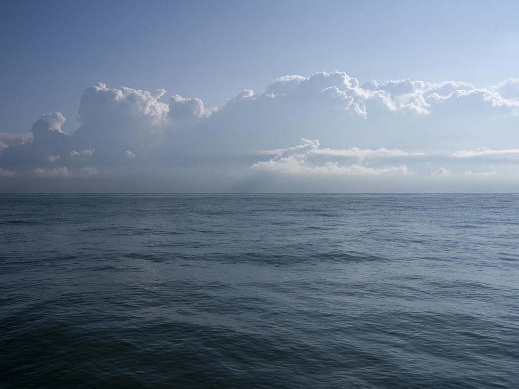 A cloud bank forms out over Lake Michigan, a day that reflects summer on the lake. Stretching up from the horizon line on September 13th, 2023.