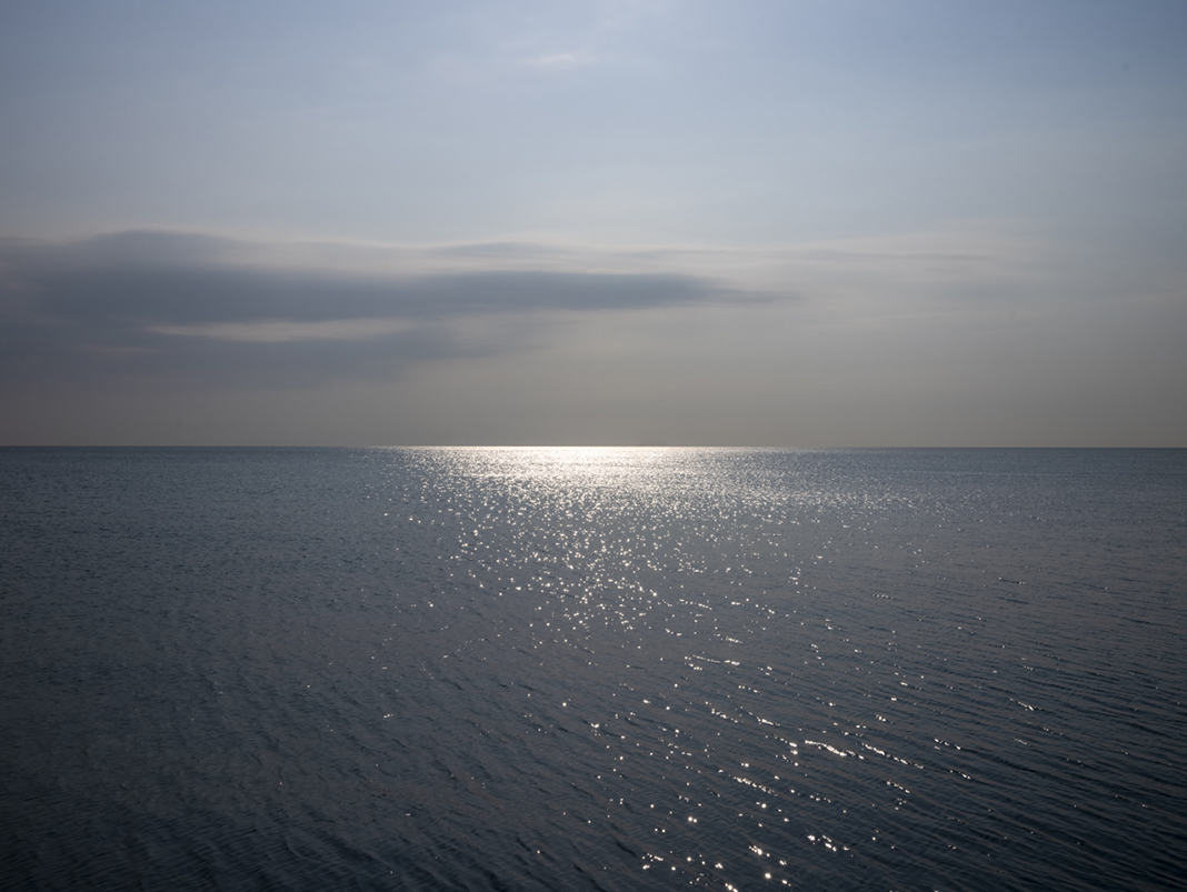 Summers end on the lake from late August 2023. This photograph marks the end of season on the lake from photographer Lincoln Schatz. The hazy sky, the final high temperatures, a quality to the air and water that heralds changes to our landscape can all be seen here.