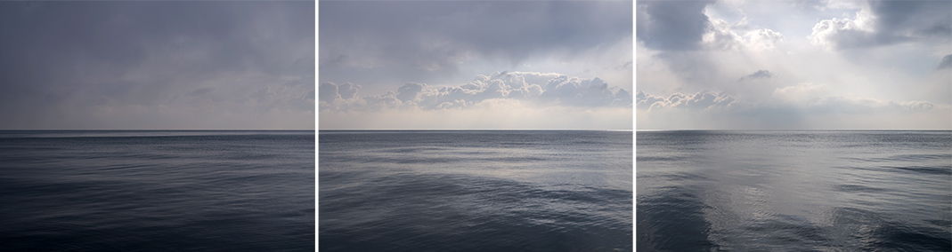 Lake Michigan appears here in three expansive photographs that come together to create a large scale panorama photograph of this remarkable freshwater lake. Each panel of this triptych explores the subtlety of early morning light in the clouds and water.