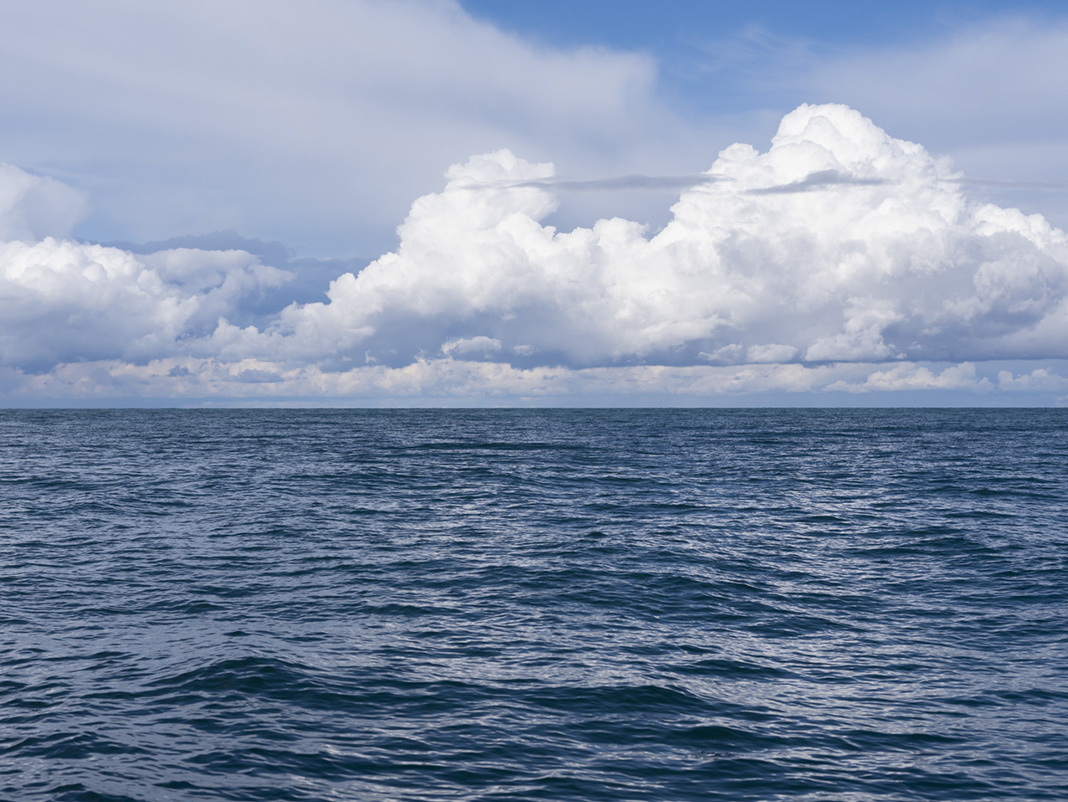 A windy day on Lake Michigan from October 1st, 2020. Multiple cloud types are filling the sky. Overlapping shape, color and form.