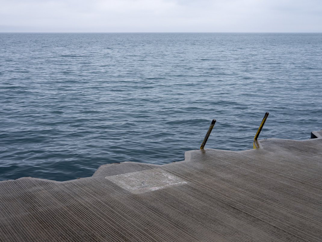 A spring morning on Lake Michigan. Cool waters push against the lake wall and soon the serrated concrete and steel platform will fill with people wanting to spend a day or even just an hour at the lake.
