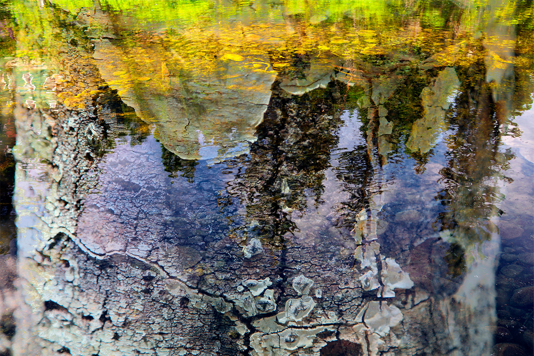 Multiple photographs come together to create the artwork Portrait of a Walk, Aspen 2, where the landscape is reflected in the waters of a stream. This work is part of a limited edition that explores the mountains and landscapes surrounding Aspen Colorado through digital intervention. The six works in this edition are created through the layering and alteration of multiple images, with each photograph working and interacting with the next. Creating a hybrid hyper-real landscape that reimagines a walk through the mountains as a memory might appear to us.