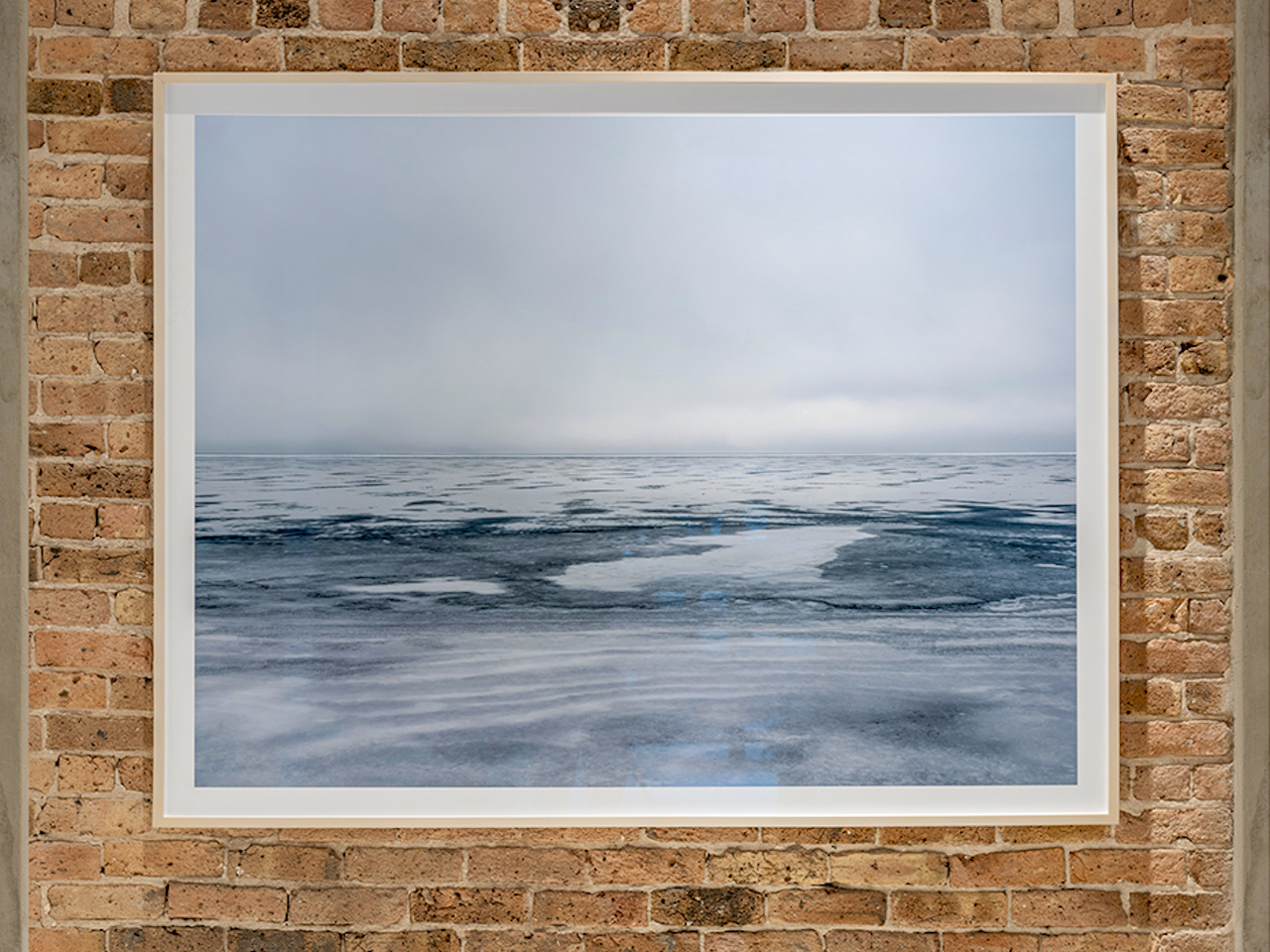 This framed photograph, Lake Series, February 15th, 2018, features an ice filled landscape that will soon appear here on Lake Michigan. The winter months produce a range of qualities and behavior in the lake that is filled with immense beauty and dramatic complexity. The winter months reward the cold days with landscapes that continue to astonish me.