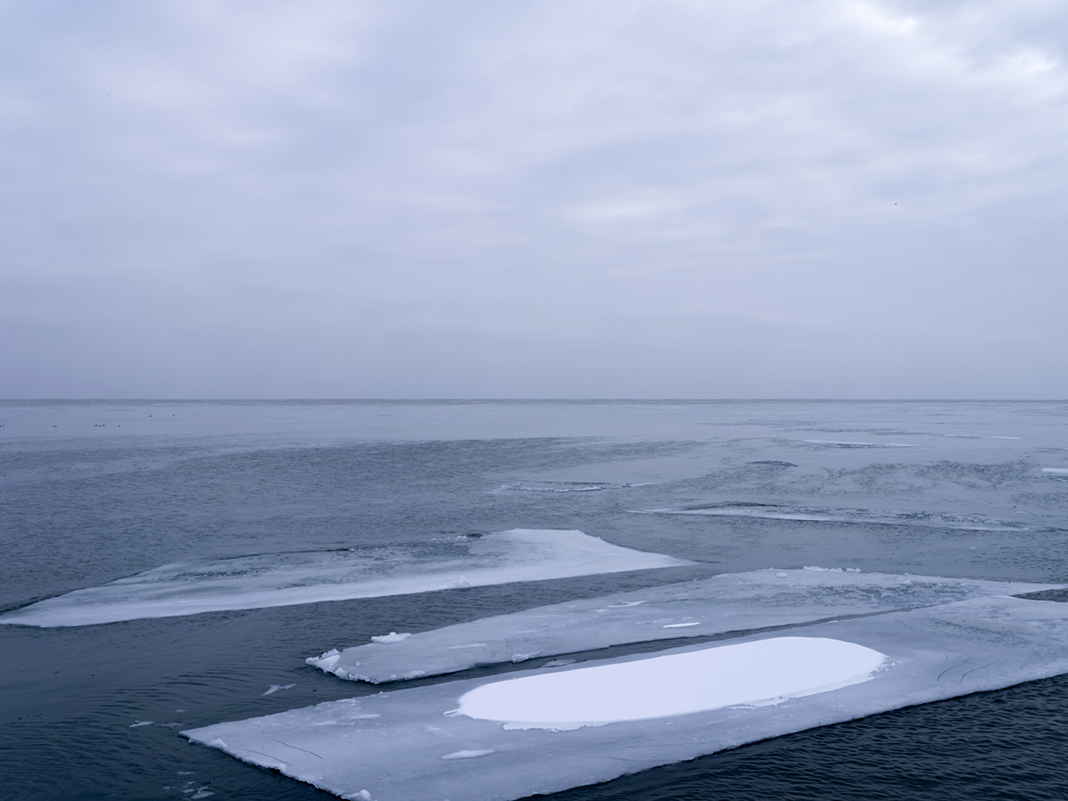 Geometric shapes appear on Lake Michigan. There is something that is so visually arresting about the ice that forms in Lake Michigan. It creates difference in the landscape, it reorients how you see the lake. And it can take many shapes, like here, where hard edged geometric slabs of ice create a sharp contrast to the waters of the lake.