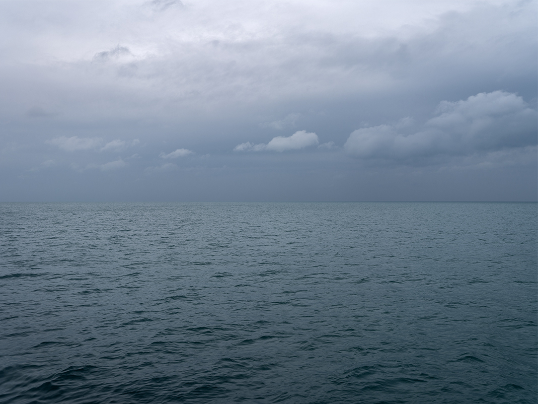 Subtle interplay between light and shadow in the sky over Lake Michigan on October 25th, 2023. Full photograph in slide two. This photograph is part of the Lake Series, an ongoing edition of photographs that document the mercurial nature of the lake.
