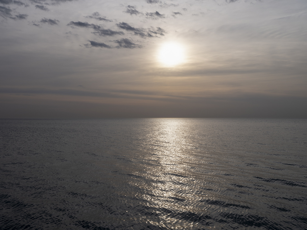 April 6th, 2021 and the lake is rendered in metallic tones warmed with a patina created from the hazy overcast conditions. A unique landscape not often seen on Lake Michigan.
