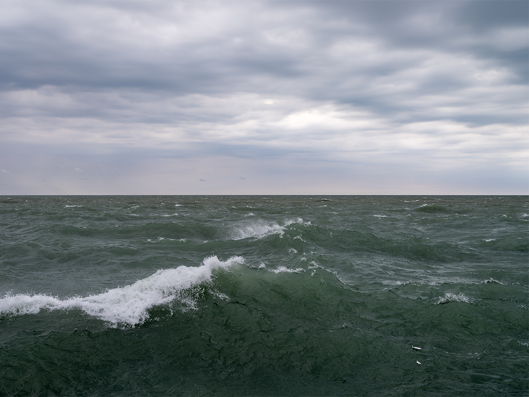 A mid October day on Lake Michigan from a few weeks ago. Waves crest and crash as storms threaten. This is a photograph from the Lake Series. A serial exploration of a particular place and a portrait over time.