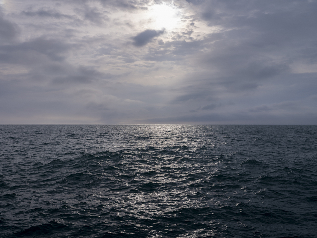 The lake is building in anticipation of storms steel blue in color. The edges of waves are dramatically etched in the morning light. The sun is carving the waters in high contrast light. This photograph is from April 28th, 2021.