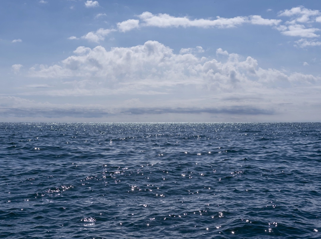 look back at a photograph from the Lake Series that embodies a summer lake day on Lake Michigan. There is something about a day like this, in the relationship between sun and water and the way the light shifts and glitters on the surface, that is unmistakably the summer season.