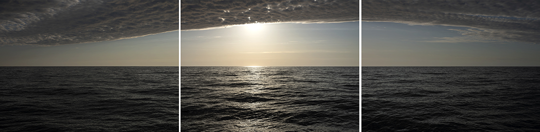 Clouds just hide the sun late in the morning. The interplay between the two creates a dramatic bronze and black landscape on Lake Michigan in this large scale triptych. From my ongoing Lake Series Panoramas edition. 