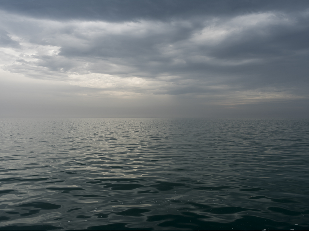 The waters of Lake Michigan undulate beneath softly shifting sunlight in this photograph from the Lake Series. An early work in the edition, this is May 10th, 2017.