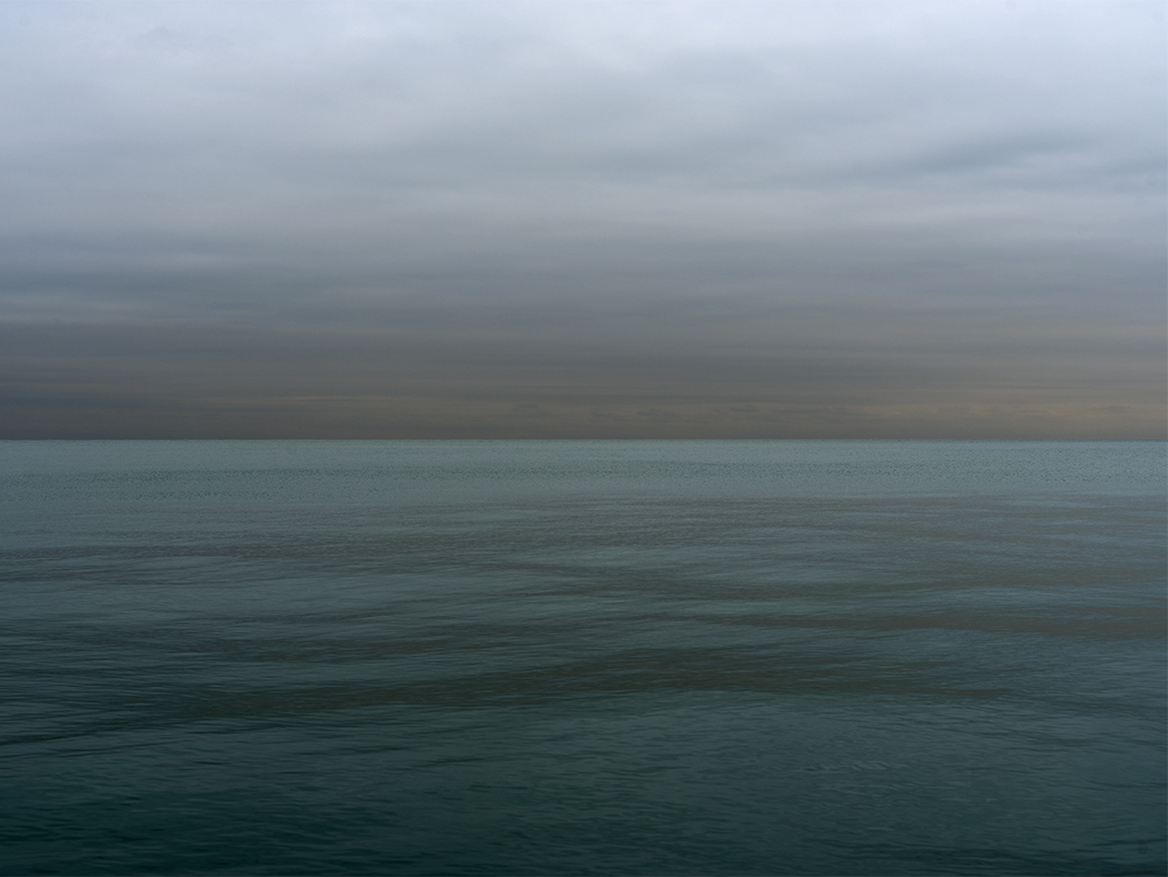 Over two years ago I came to the lake and stood on the shore. I sat waiting as it came into the light at dawn. Revealing waters emerald in tone, with gently shifting colors in both sky and water. The full photograph can be seen in slide two. This is from the Lake Series, October 27th, 2020.