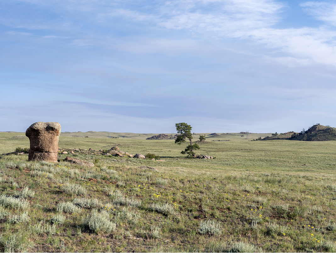 Tie Siding, Wyoming (10) features the sweeping grasslands of the western United States. Rock outcroppings dot the land, creating a visual rhythm.