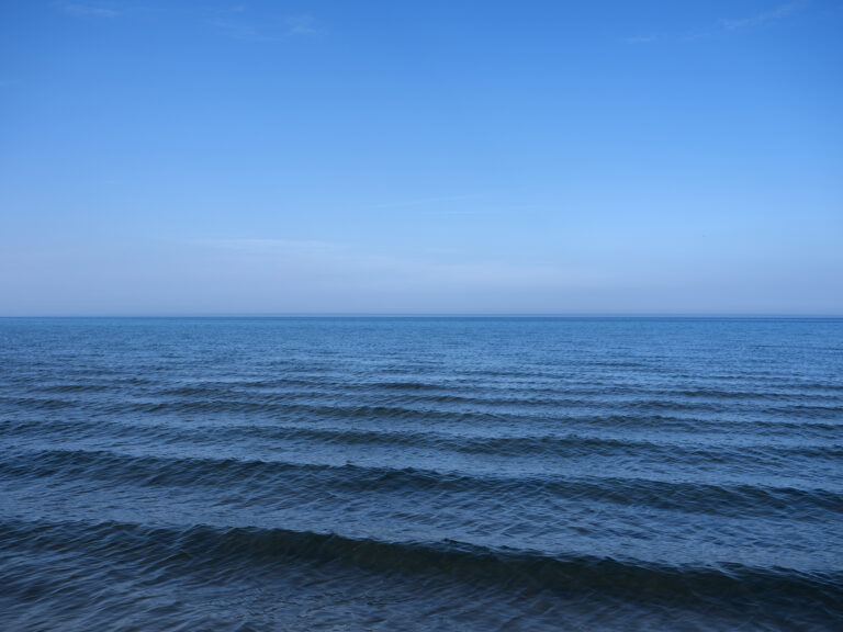 Rolling waves like an alligators back shift towards shore in this photo from the Lake Series by Lincoln Schatz.