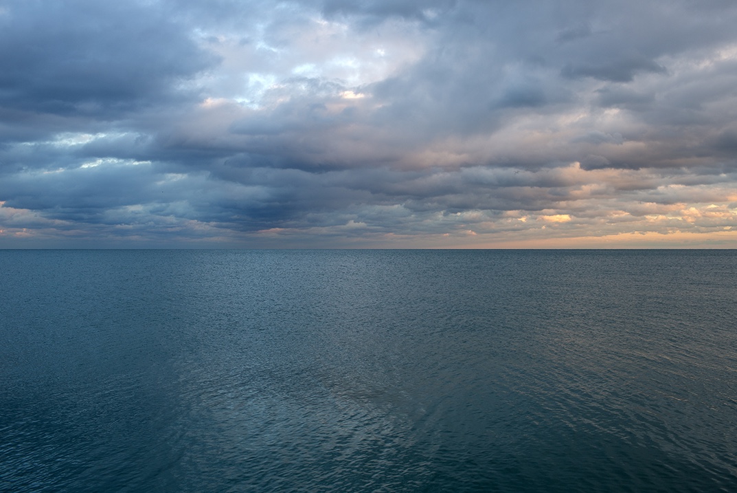 Ethereal golden light mingles with gently modulating greens and blues in this Lake Series photograph from late 2015. The water ripples in tight textural formations, creating a marbled pattern, in the golden hour light.