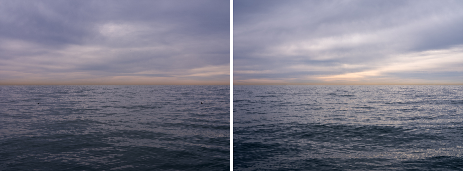 Purple cloud filled skies softly float over lake waters.