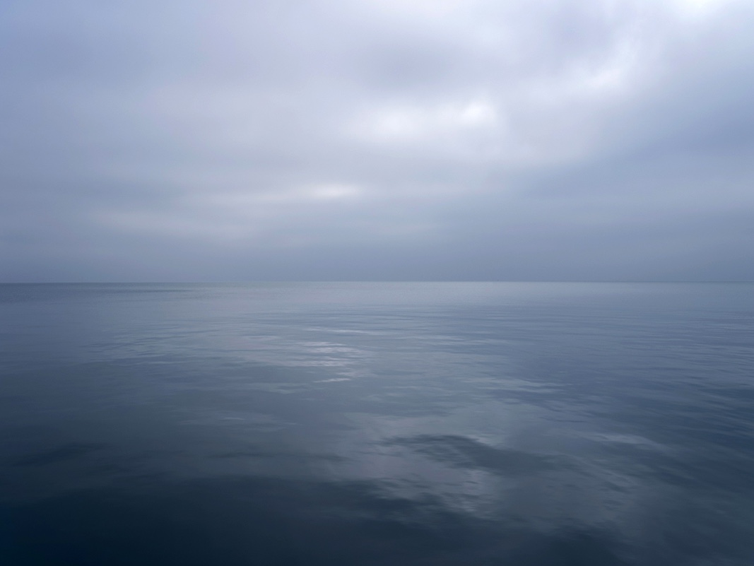Gentle tones that imperceptibly shift in largely monochromatic color on the lake today. The lake and sky become one on January 24th, 2023. With no wind that day the sky and water almost came to a near stop, allowing for both to take on  a muted character.