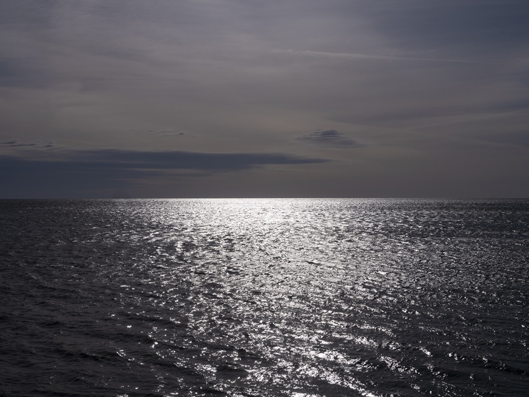 A look back at March 19th, 2024 in the Lake Series on a morning where the elements work together to create a surreal landscape in dark blue, black and purple tones. The clouds sit in high contrasting layers in the sky at dawn.