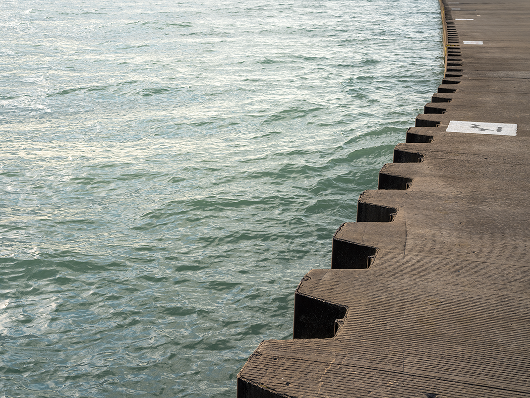 The serrated steel and concrete edge of the lake wall creates an abrupt break between land and water on Lake Michigan. From The Shore, an edition of fine art photography focused on the relationship between the lake and the land that line the east edge of the city of Chicago.
