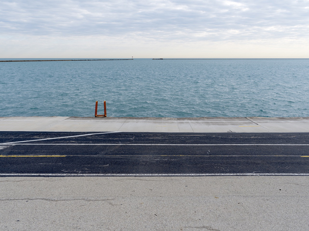 The Shore is an edition of fine art photographs focused on the interrelationship between land and water along the edges of Lake Michigan. Having already begun work on the Lake Series in 2015, I began to open my camera to the broader landscapes that adjoin the lake over time. Those photographs became The Shore edition. This is The Shore (1).