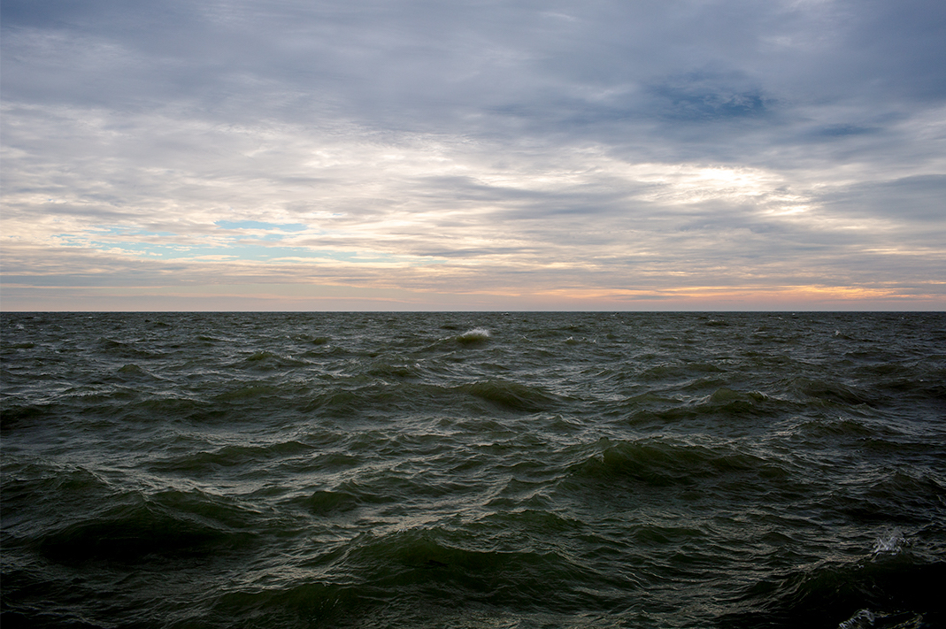 From early in the Lake Series, a day on Lake Michigan where large waves are starting to form white caps out away from shore. First light brings warm and cool tones together in an endlessly evolving landscape.