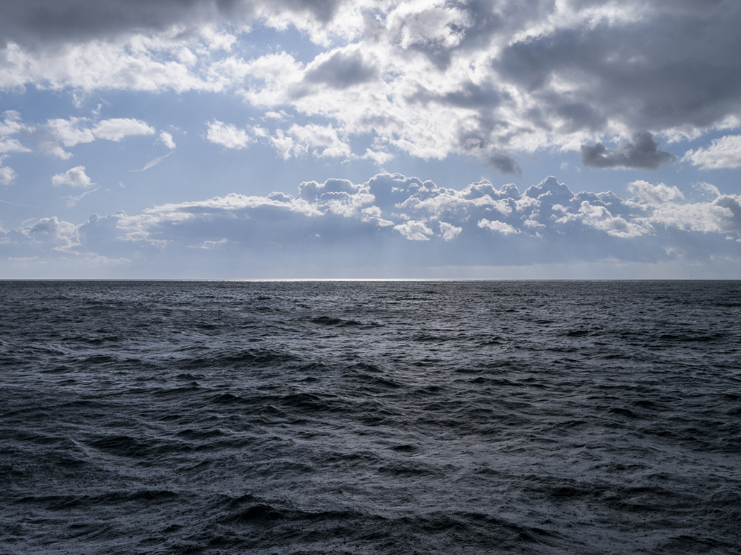 April 17th, 2024 and the light on this morning is creating a beautiful interplay between sky and water, highlighting the edges of clouds and creating a brilliant slash near the horizon in this striking day on Lake Michigan.