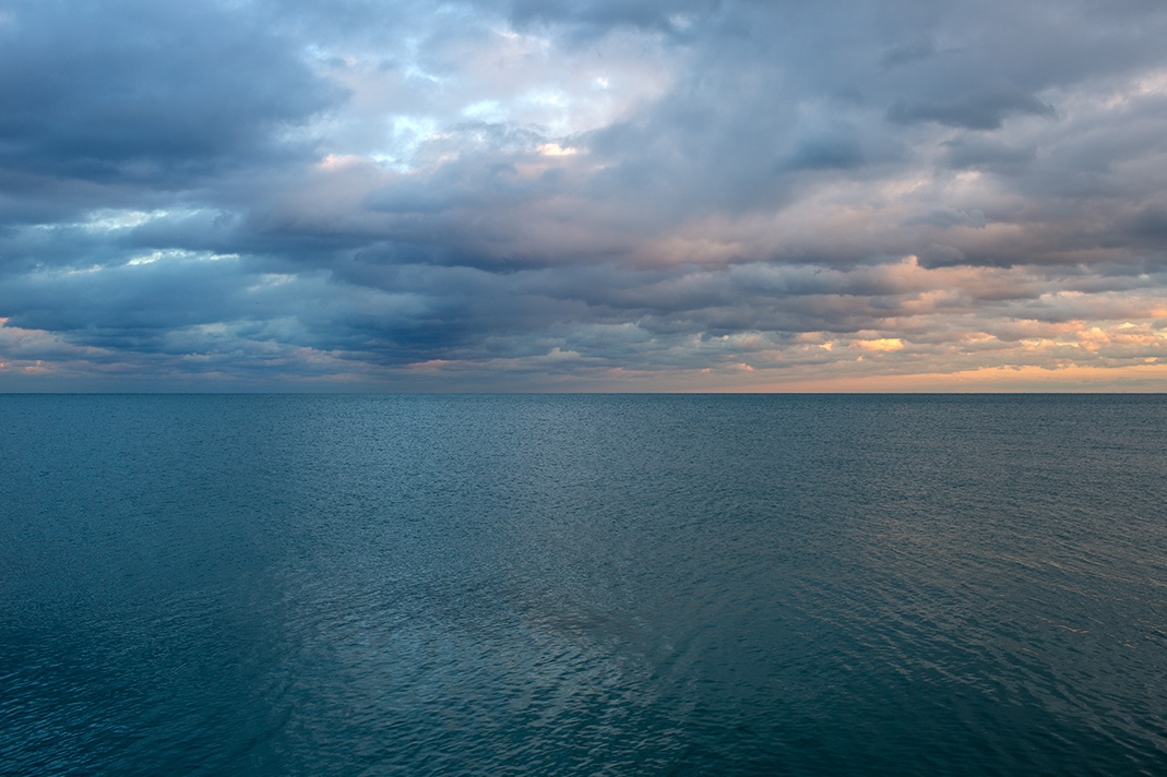 The sky and lake are alive on this evening, the color and light changing at the end of the day. The light is shifting between cool and warm tones, while the clouds change form overhead.