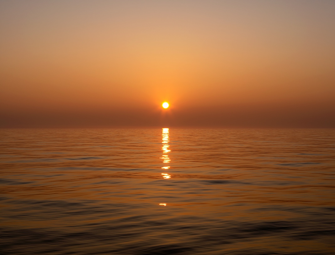 The sun rises out over the water on Lake Michigan in this photograph from the Lake Series. This is the Lake Series, March 25th, 2020.