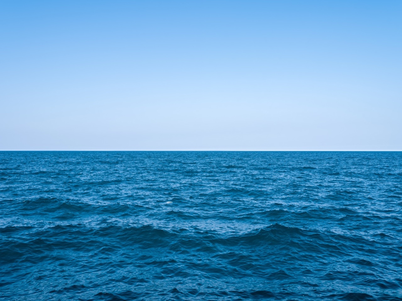 Summer blues on Lake Michigan mean perfectly clear skies and lake waters filled with waves building in the wind.